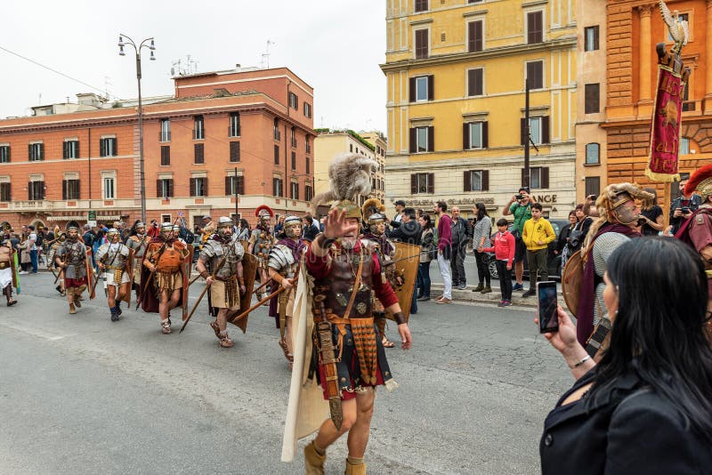 ROME, ITALY - APRIL 22, 2019: Natale di Roma or Dies Romana, people dressed as gladiators and centurions parading in front of the Coliseum to celebrate the birth of Rome dating back to April 21st 753 BC. ROME, ITALY - APRIL 22, 2019: Natale di Roma or Dies Romana, people dressed as gladiators and centurions parading in front of the Coliseum to celebrate the birth of Rome dating back to April 21st 753 BC