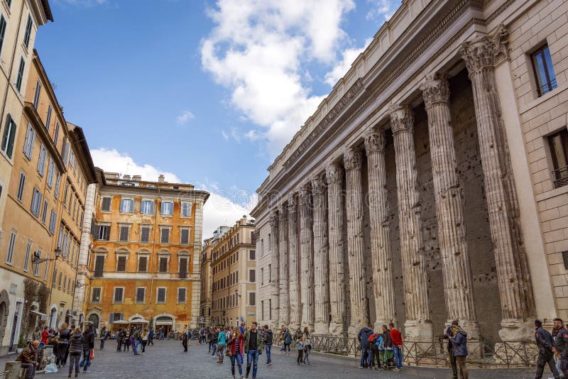 Rome, Italy, february 18, 2017: people walking near the Temple of Hadrian in Piazza di Pietra in Rome, Italy. Rome, Italy, february 18, 2017: people walking near the Temple of Hadrian in Piazza di Pietra in Rome, Italy.