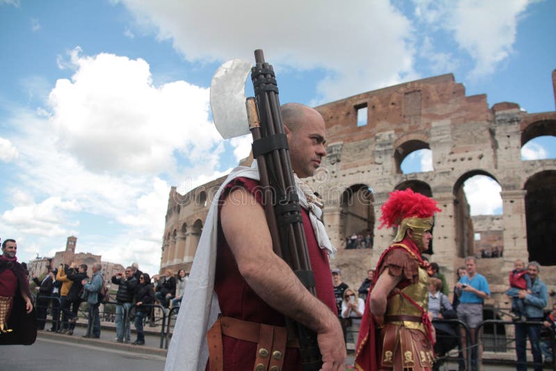 An actor dressed as Lictor, and carrying a fasce in front of the Colosseum as part of a parade and re-enactment to celebrate the, Natale di Roma, birthday of Rome. An actor dressed as Lictor, and carrying a fasce in front of the Colosseum as part of a parade and re-enactment to celebrate the, Natale di Roma, birthday of Rome.