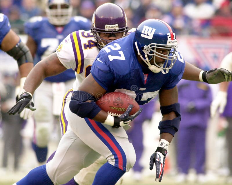 Running back Ron Dayne of the New York Giants barrels thru the Minesota Vikings defense at the NFC Championship game. The New York Giants defeated he Minnesota Vikings to gain a berth in Super Bowl XXXV. Also the New York Giants went on to defeat the Minnesota Vikings in the NFC Championship game by a final score 41 to 0 on 01/14/01. (Image taken from color slide)