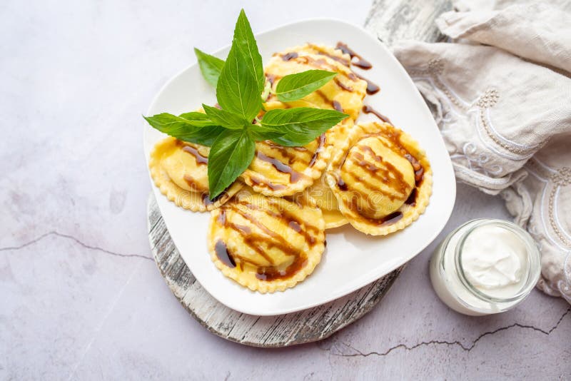 Round Ravioli with cheese and spinach topped with basil and balsamic glaze. Round Ravioli with cheese and spinach topped with basil and balsamic glaze