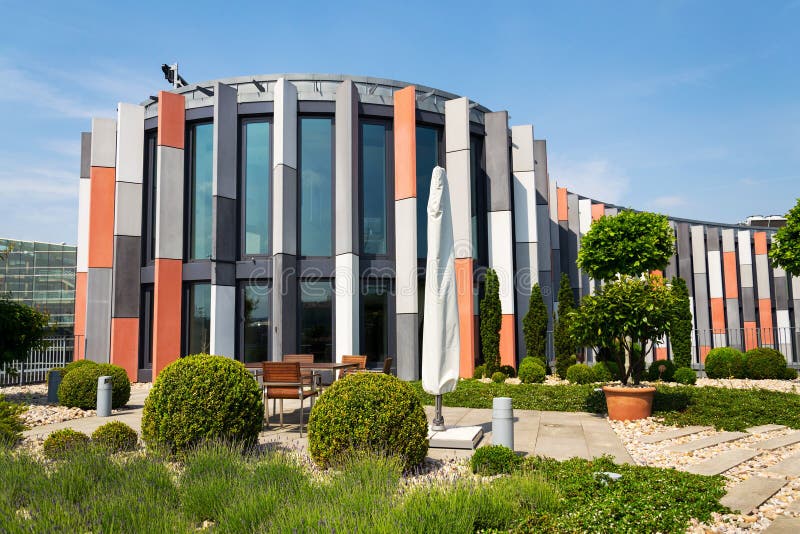 Roof garden terrace with brise soleil sun breakers on modern office building facade, heat protection, global warming, sustainable