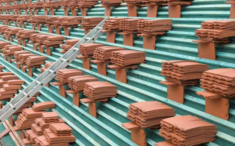 Roof tiles stacked on a roof close up, UK. New roof tiles stacked on a roof ready for laying on a house according to building regulations, UK royalty free stock images Roof tiles stacked on a roof close up, UK. New roof tiles stacked on a roof ready for laying on a house according to building regulations, UK royalty free stock images