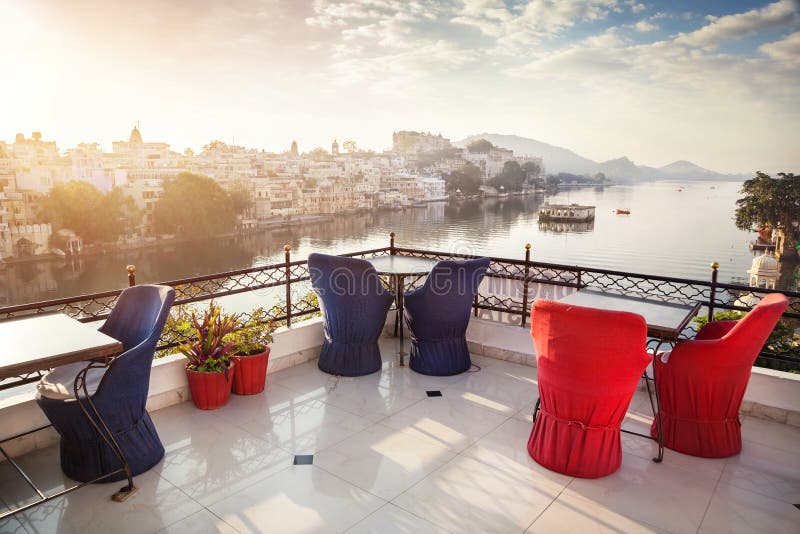 Roof top restaurant with beautiful view to Lake Pichola in the morning in Udaipur, Rajasthan, India. Roof top restaurant with beautiful view to Lake Pichola in the morning in Udaipur, Rajasthan, India