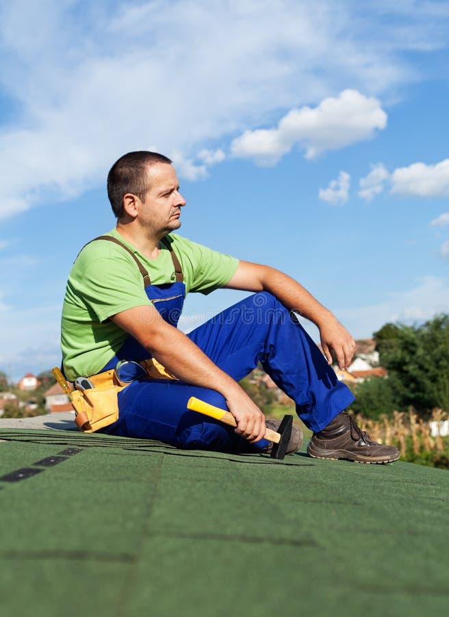 Roofer worker resting on top of building stock images