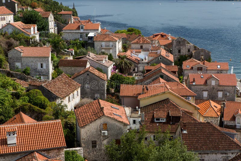 Roofs of old houses in Perast and Bay with mountains in Montenegro stock photography Roofs of old houses in Perast and Bay with mountains in Montenegro stock photography