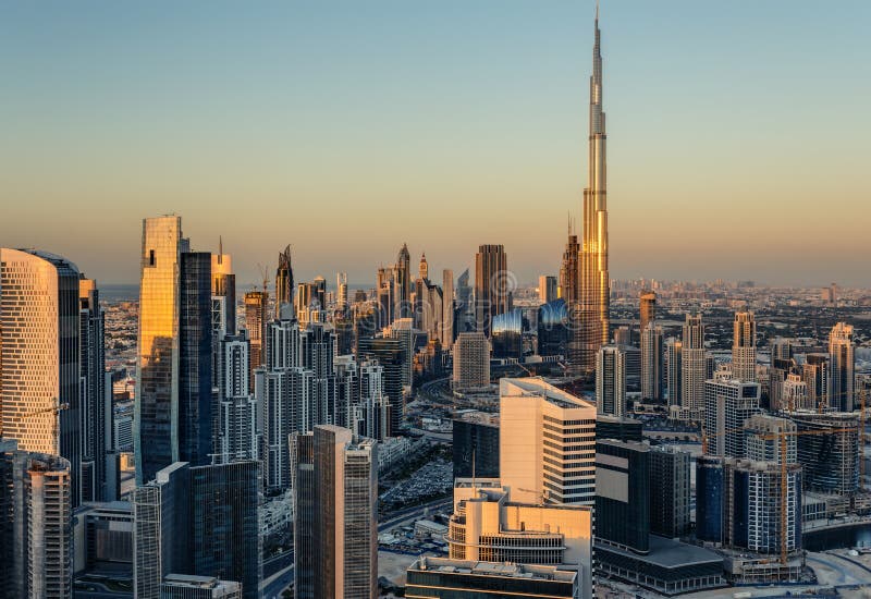 Rooftop view of Dubai's business bay towers at sunset. Famous Dubai's landmark.