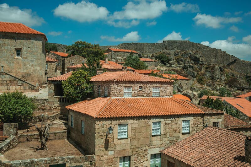 Rooftops of old houses and large wall