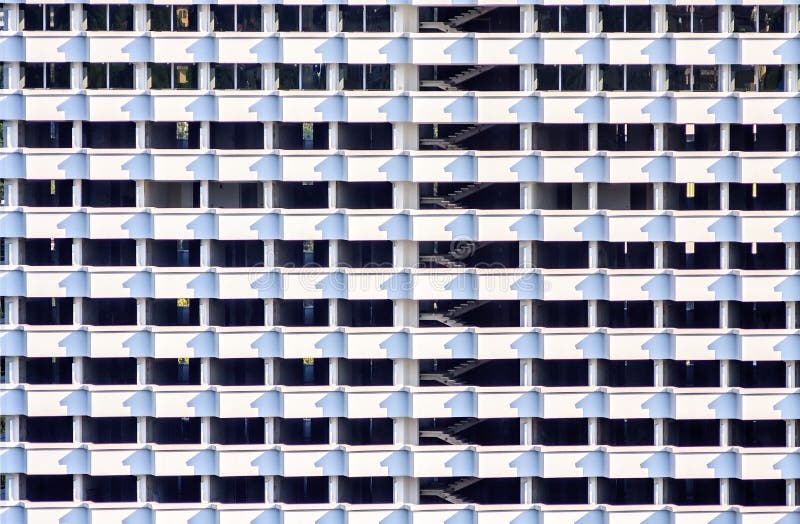 Room cells of many storeyed building structure. Black and white abstract building exterior texture and background with perpendicular lines