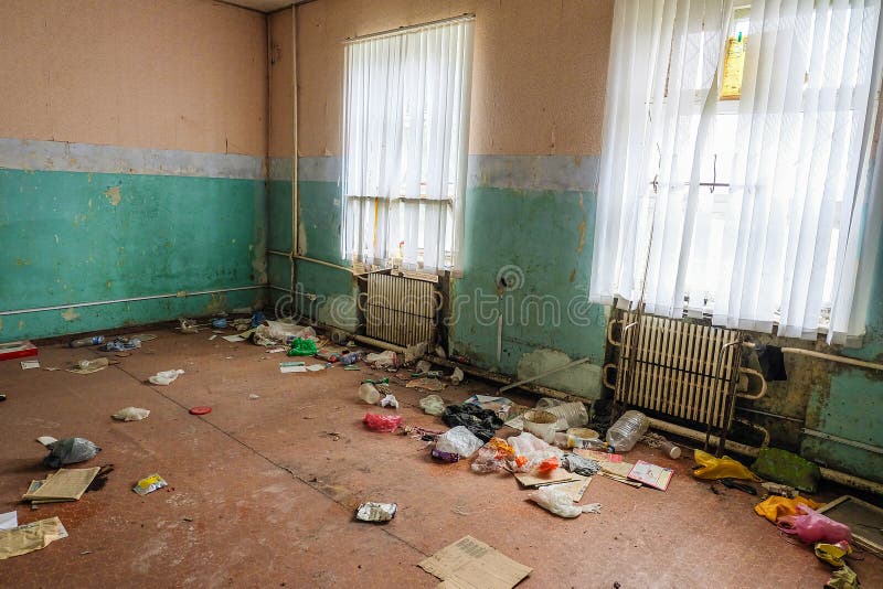 Room of an Old Abandoned Building Filled with Trash on the Floor Stock