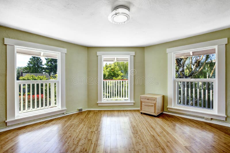 Room with tree windows in empty house