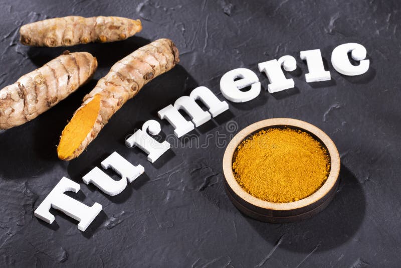 Roots and turmeric powder - Curcuma longa stock photo