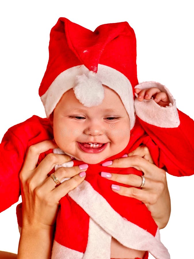 Ropa del bebé para los sombreros de Papá Noel que llevan a cabo la Navidad fotos de archivo Ropa del bebé para los sombreros de Papá Noel que llevan a cabo la Navidad fotos de archivo