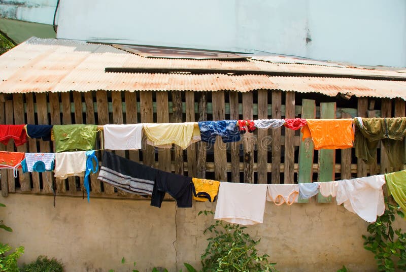 Colourful clothes drying outside on clotheswire. Colourful clothes drying outside on clotheswire