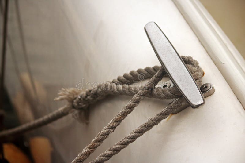 ROPE AROUND CLEAT on SIDE of a BOAT Stock Photo Image of view, area