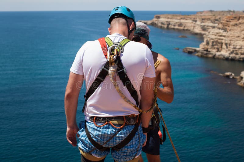 Rope Jumping Off a Cliff with a Rope in the Water. the Ocean. Sea