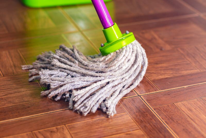 Rope Mop On The Tile Floor And A Puddle Of Water. Stock Image - Image ...