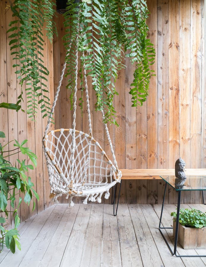 Rope swing chair stock image. Image of wind, lush, wooden 76577539