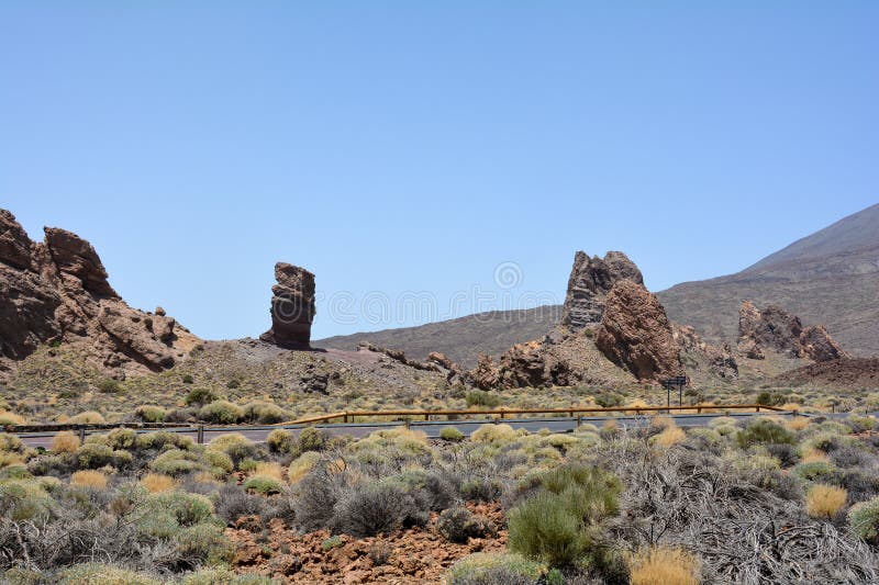 The bizarrely shaped Roque Cinchado rock of volcanic rock in Teide National Park on the Canary Island of Tenerife, Spain. The bizarrely shaped Roque Cinchado rock of volcanic rock in Teide National Park on the Canary Island of Tenerife, Spain