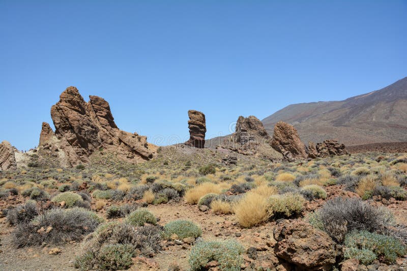 The bizarrely shaped Roque Cinchado rock of volcanic rock in Teide National Park on the Canary Island of Tenerife, Spain. The bizarrely shaped Roque Cinchado rock of volcanic rock in Teide National Park on the Canary Island of Tenerife, Spain