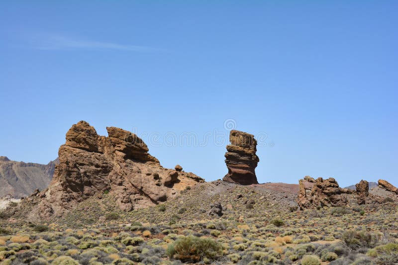 The bizarrely shaped Roque Cinchado rock of volcanic rock in Teide National Park on the Canary Island of Tenerife, Spain. The bizarrely shaped Roque Cinchado rock of volcanic rock in Teide National Park on the Canary Island of Tenerife, Spain