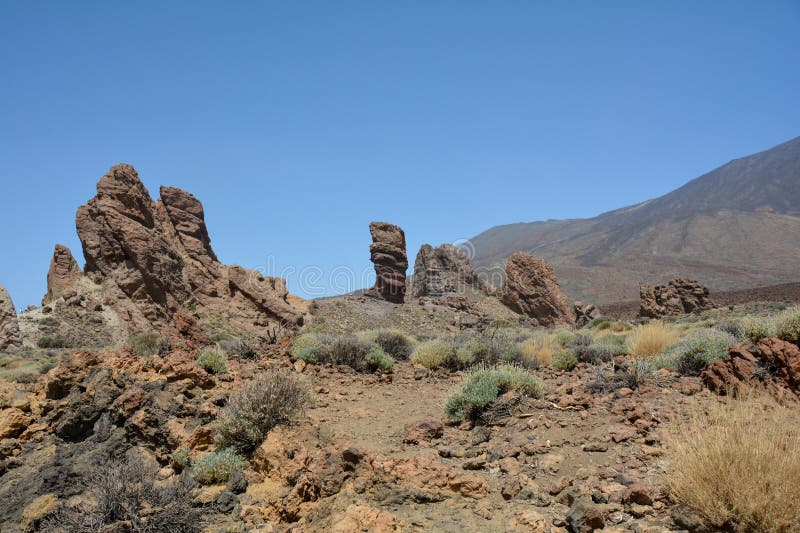 The bizarrely shaped Roque Cinchado rock of volcanic rock in Teide National Park on the Canary Island of Tenerife, Spain. The bizarrely shaped Roque Cinchado rock of volcanic rock in Teide National Park on the Canary Island of Tenerife, Spain