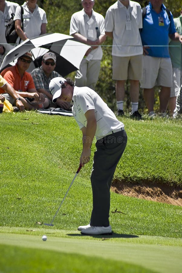 Rory McIlroy, gently taps the ball to putt out on the 8th hole, eagerly watched by the crowd, visible in the background. Sun City Gary Player Golf Course. Nedbank Million Dollar Golf Tournament 2009. Nedbank Golf Challenge 03 - 06 December 2009. Rory McIlroy, gently taps the ball to putt out on the 8th hole, eagerly watched by the crowd, visible in the background. Sun City Gary Player Golf Course. Nedbank Million Dollar Golf Tournament 2009. Nedbank Golf Challenge 03 - 06 December 2009.