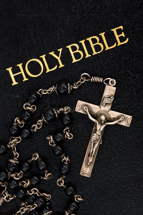 Old, Worn Rosary on a Well-Used Bible. Old, Worn Rosary on a Well-Used Bible