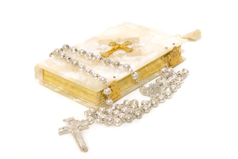 Rosary and First Communion book isolated on white background. Rosary and First Communion book isolated on white background