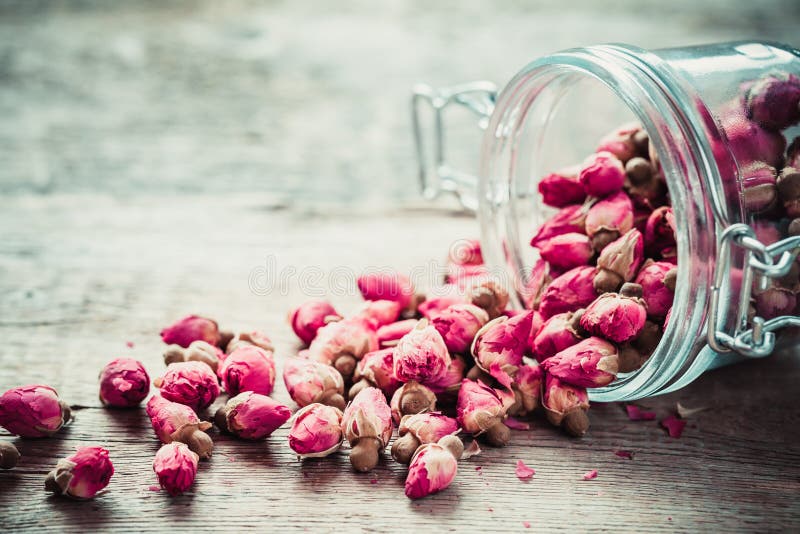 Rose buds in glass jar.