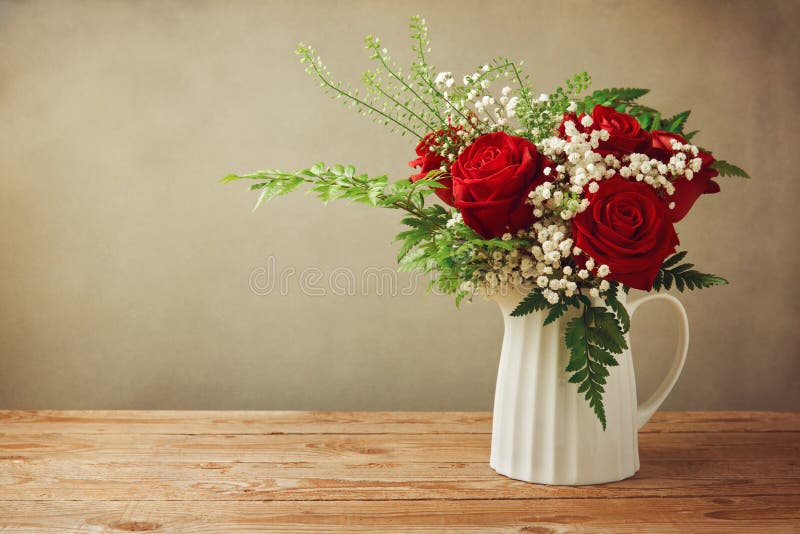 Rose flower bouquet on wooden table with copy space