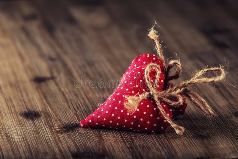 Valentines day. Red cloth handmade hearts on wooden background - table. Valentines day. Red cloth handmade hearts on wooden background - table