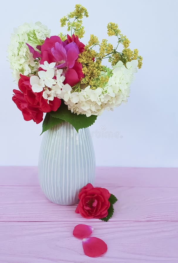 Rose vase, autumn flowers on wooden background beauty