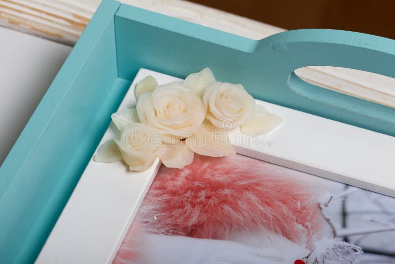 Roses with petals made of white polymer clay. Woman stirs glue with a  brush. Crafts from polymer clay Stock Photo - Alamy