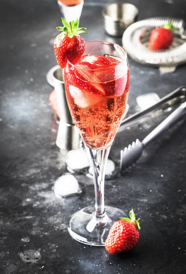 Rossini - italian alcoholic cocktail with sparkling wine, fresh strawberry puree and ice in champagne glasses, copy space, selective  focus