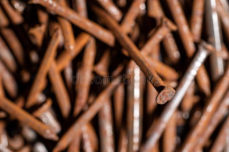 Rusty iron nails piled up in a disorderly fashion. Rusty iron nails piled up in a disorderly fashion