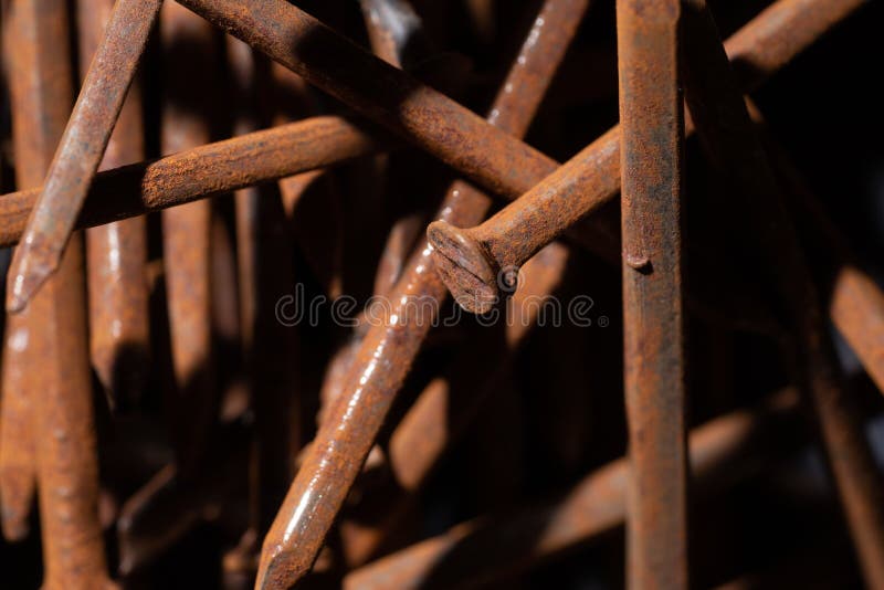 Rusty iron nails piled up in a disorderly fashion. Rusty iron nails piled up in a disorderly fashion