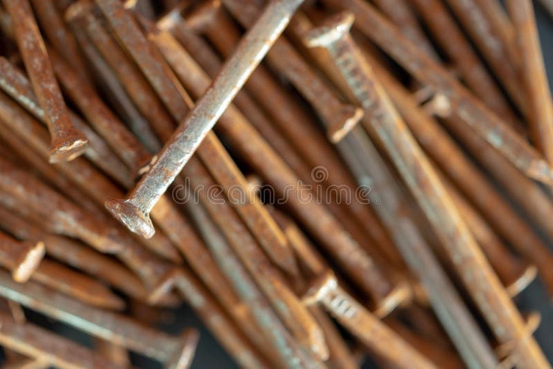 Rusty iron nails piled up in a disorderly fashion. Rusty iron nails piled up in a disorderly fashion