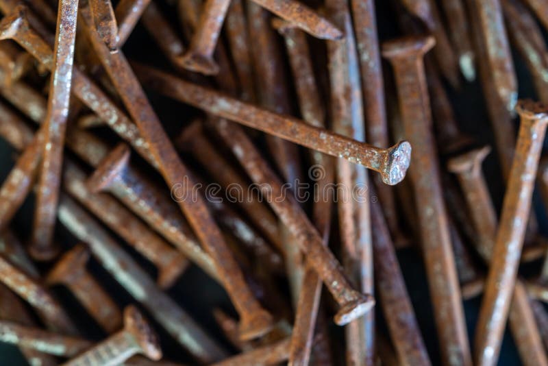 Rusty iron nails piled up in a disorderly fashion. Rusty iron nails piled up in a disorderly fashion