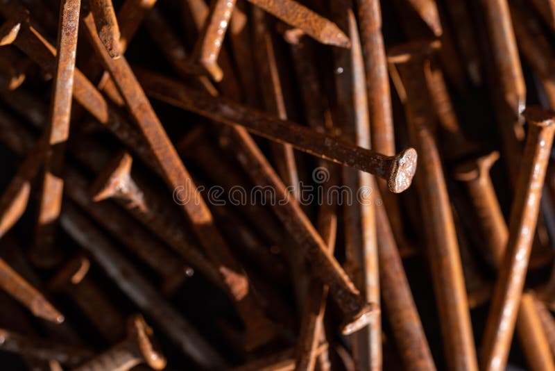 Rusty iron nails piled up in a disorderly fashion. Rusty iron nails piled up in a disorderly fashion