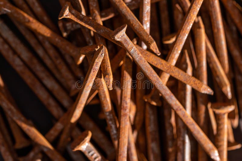 Rusty iron nails piled up in a disorderly fashion. Rusty iron nails piled up in a disorderly fashion