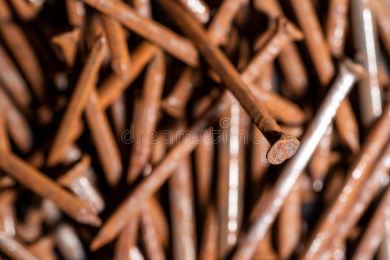 Rusty iron nails piled up in a disorderly fashion. Rusty iron nails piled up in a disorderly fashion