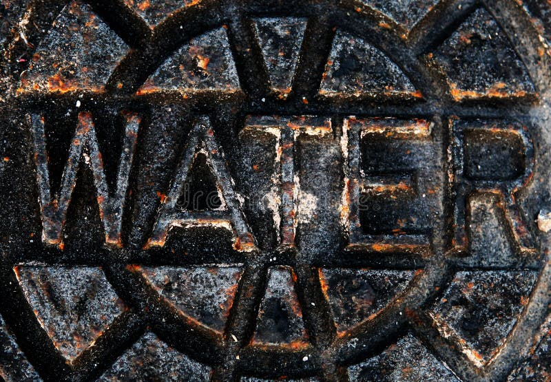 Photo of a rusty city water hole cover. Photo of a rusty city water hole cover.