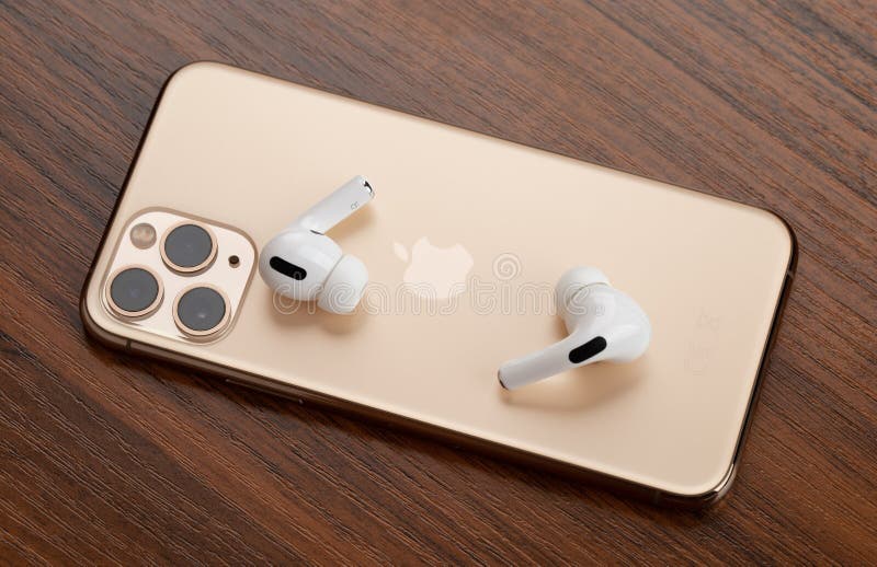 Apple Airpods Pro And Iphone 11 Pro On A Wooden Table Wireless Headphones And Smartphone Editorial Photo Image Of Iphone Charging