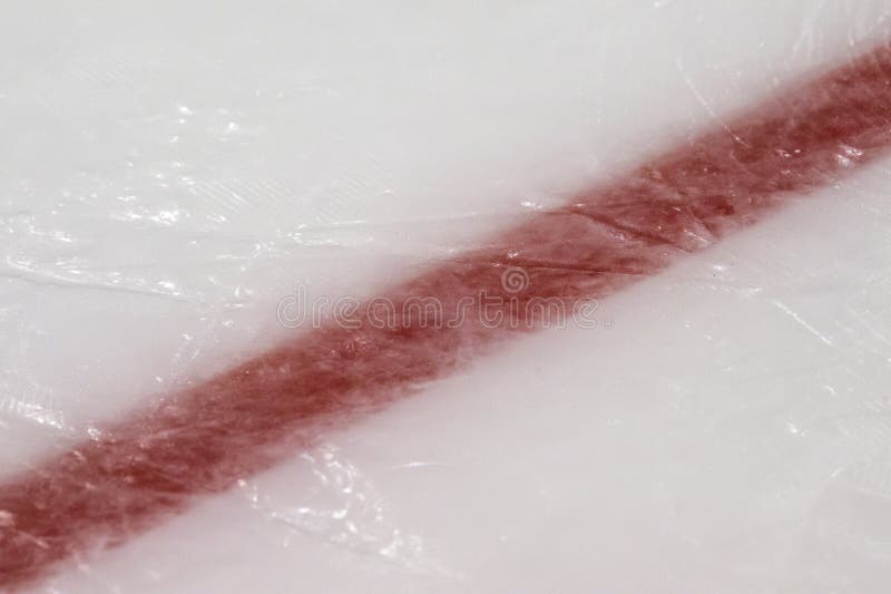 Ice hockey rink red markings closeup, winter sport background. Ice hockey rink red markings closeup, winter sport background.