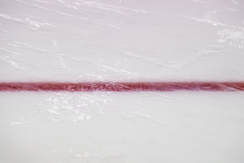 Ice hockey rink red markings closeup, winter sport background. Ice hockey rink red markings closeup, winter sport background.