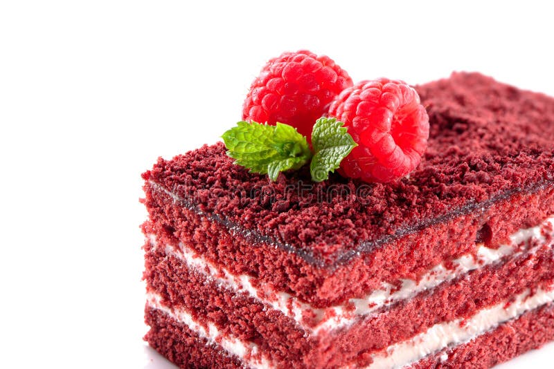 Red Velvet cake piece close-up isolated on white background with raspberries and mint leaves on top. Red Velvet cake piece close-up isolated on white background with raspberries and mint leaves on top