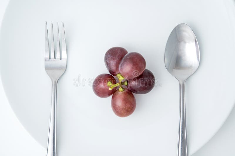Rote Traube auf weißer Platte lizenzfreies stockfoto Rote Traube auf weißer Platte lizenzfreies stockfoto
