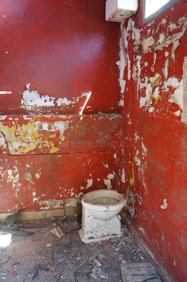 Old red bathroom in an abandoned factory. Old red bathroom in an abandoned factory.