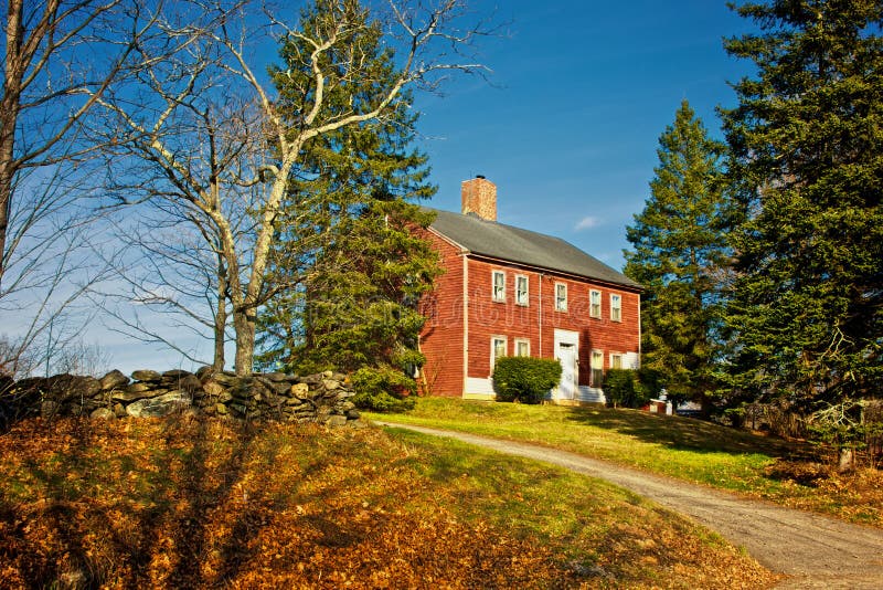 Old red colonial house up on hill in nottingham new hampshire on a fall afternoon. Old red colonial house up on hill in nottingham new hampshire on a fall afternoon